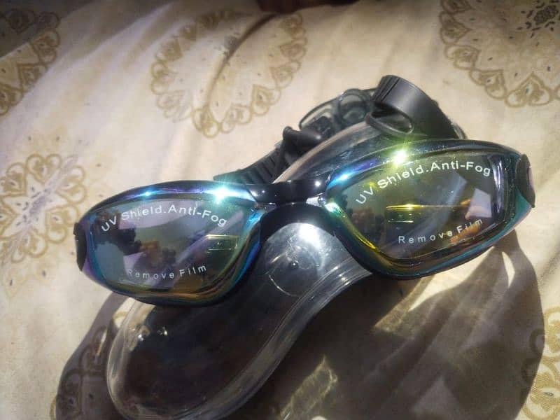 swimming goggles,anti fog and uv with attached ear strip. 0