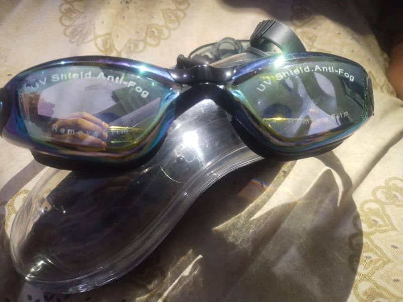 swimming goggles,anti fog and uv with attached ear strip. 1