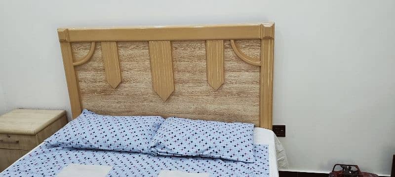 Queen 1 size bed with one side table. 1