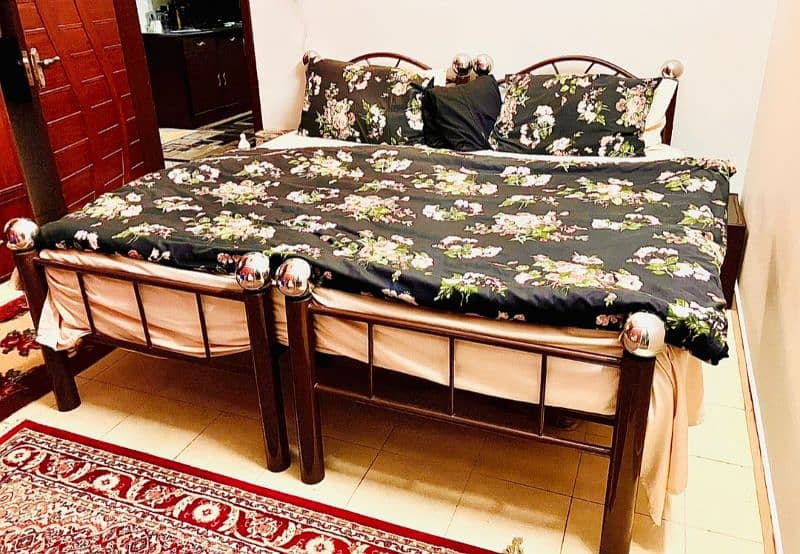 customised 2 iron rods single beds with 2 single mattress 1