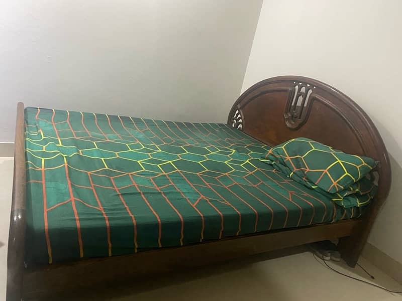 Old used wooden bed with mattress 0