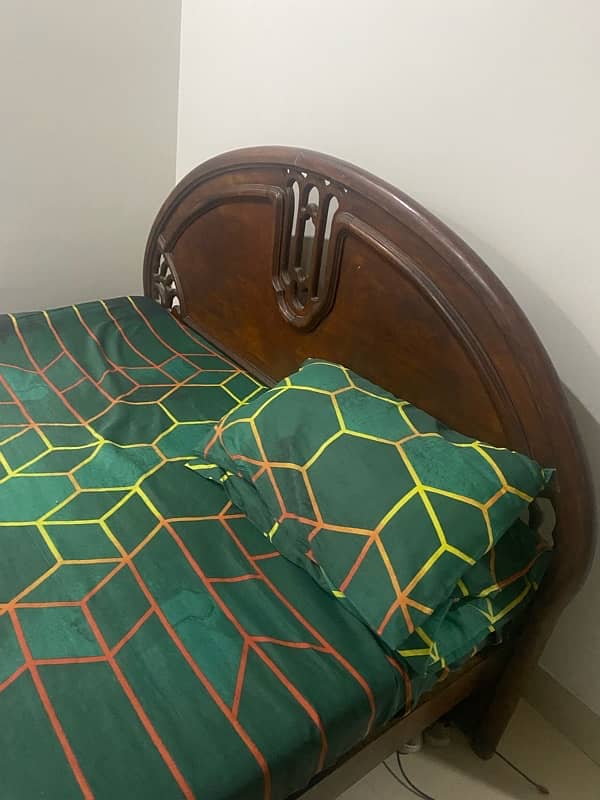 Old used wooden bed with mattress 1