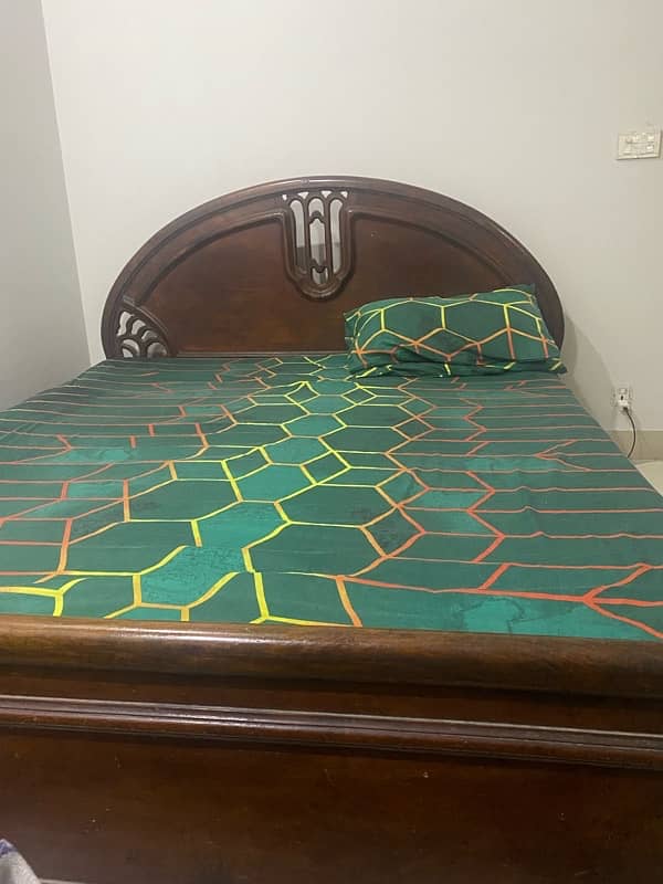 Old used wooden bed with mattress 2