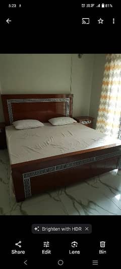 King size bed along with two side tables.