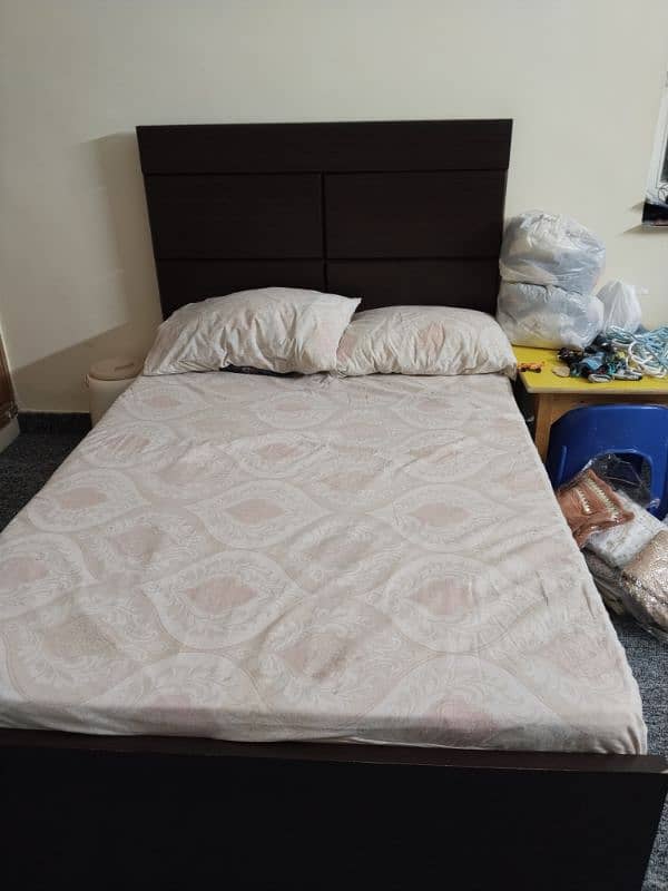 wooden bed with a brand new pack mattress. 0