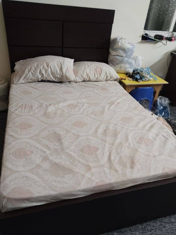 wooden bed with a brand new pack mattress. 1