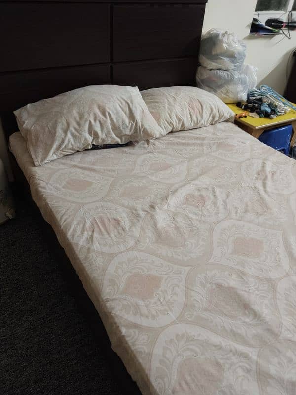 wooden bed with a brand new pack mattress. 2