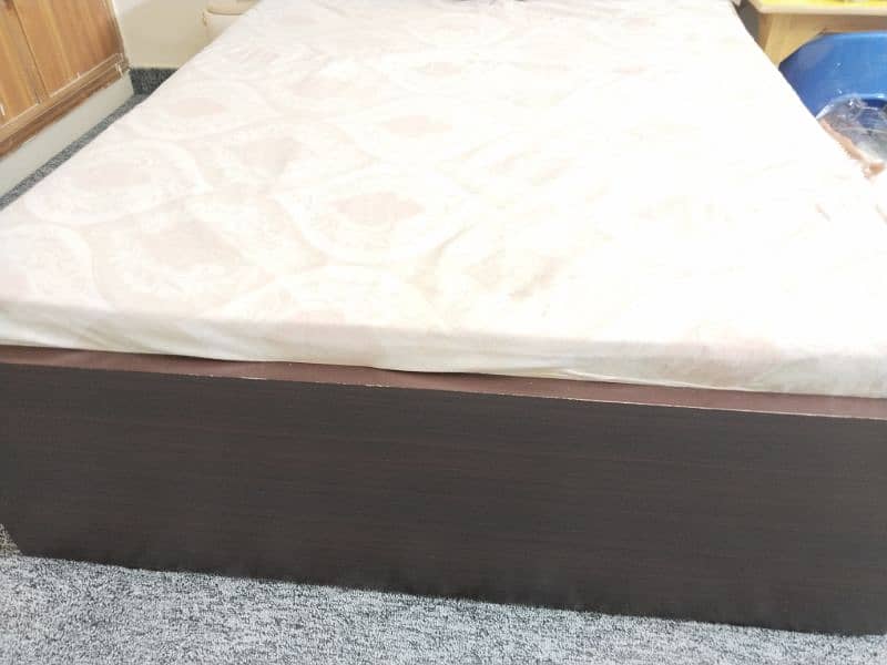 wooden bed with a brand new pack mattress. 3