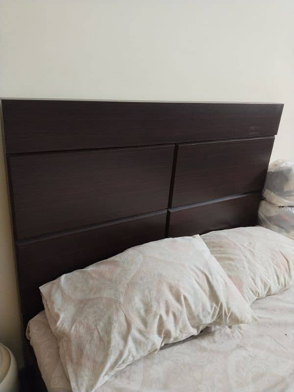 wooden bed with a brand new pack mattress. 4