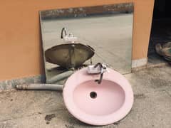 pink Porta wash basin with mirror and commode