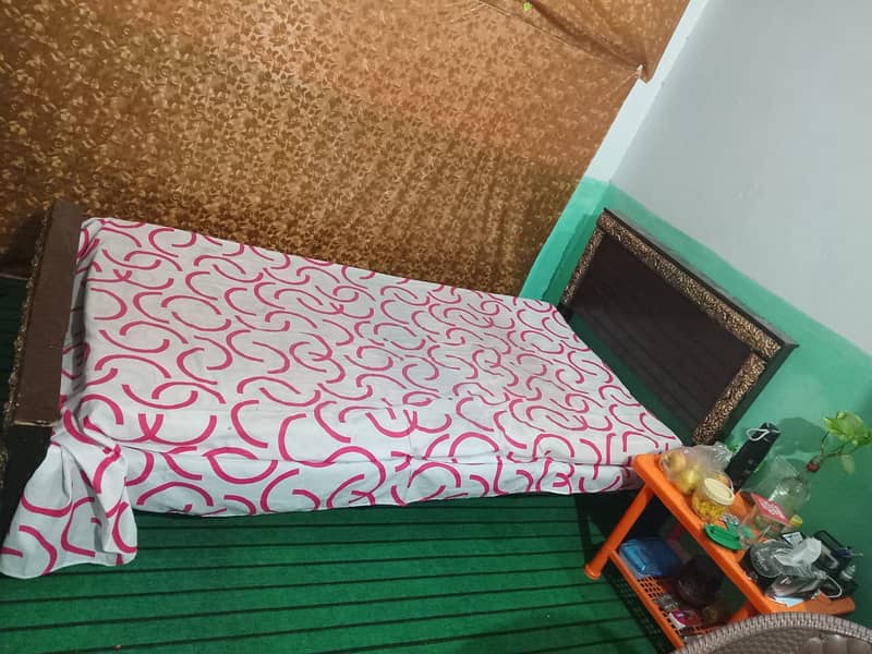 One wooden single bed with foam for sale. 1