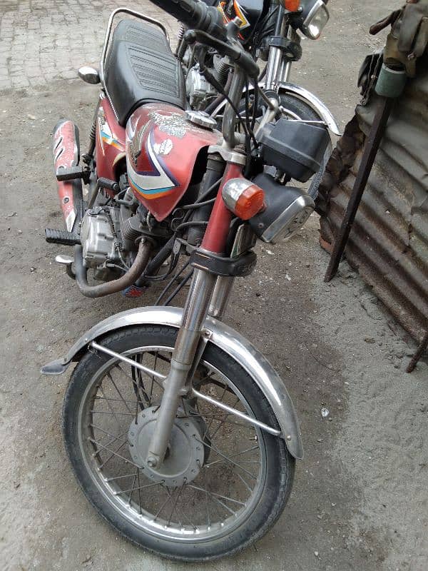 Honda 125 with golden number 1