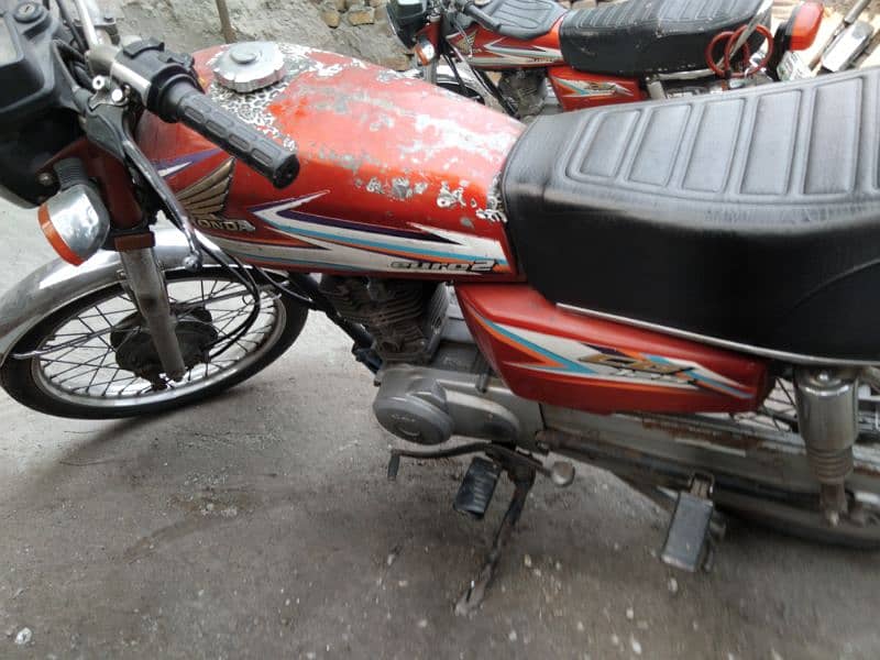 Honda 125 with golden number 2