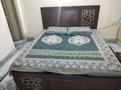 bed without mattress and show case and dressing table