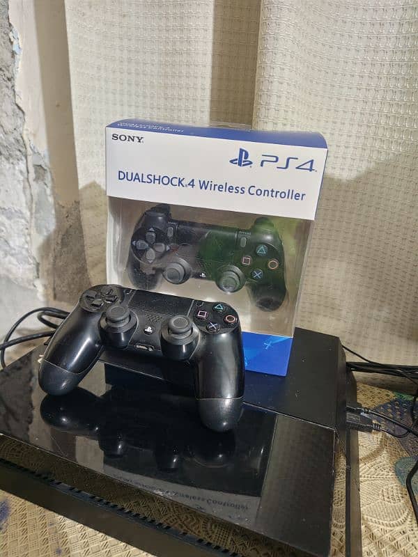 PS4 1TB non jailbreak with 4 discs & 2 controllers 2