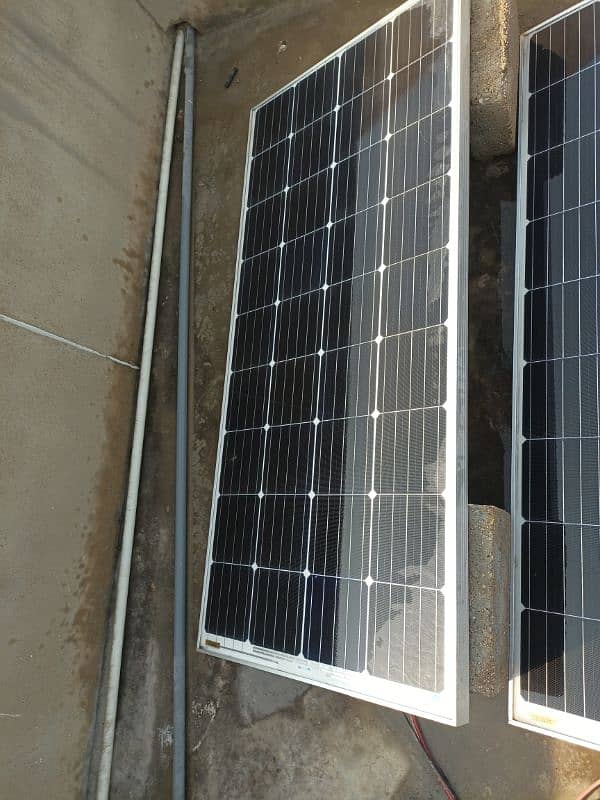 Two solar panels along with battery and controller. 1