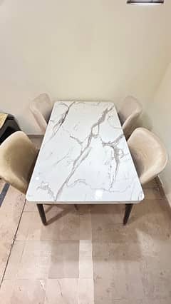 Elegant White Marble Dining Table with Beige Chairs Gold Black Accents