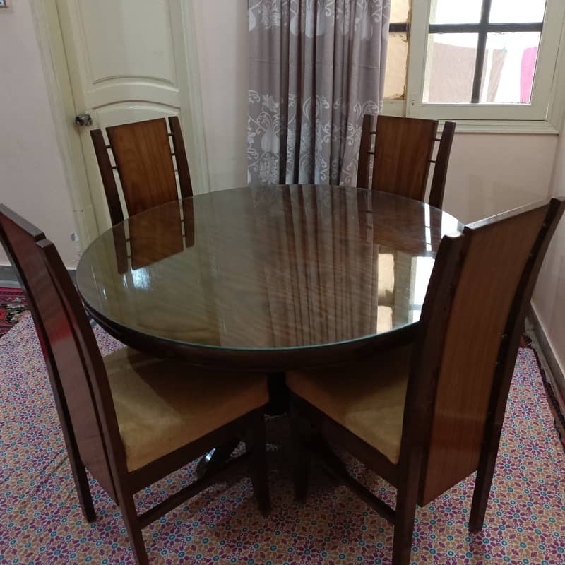 Round Dinning Table with 4 chairs. Glass placed over wooden top 1