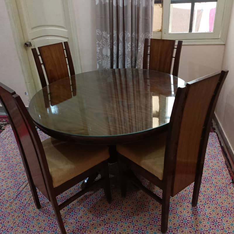 Round Dinning Table with 4 chairs. Glass placed over wooden top 2