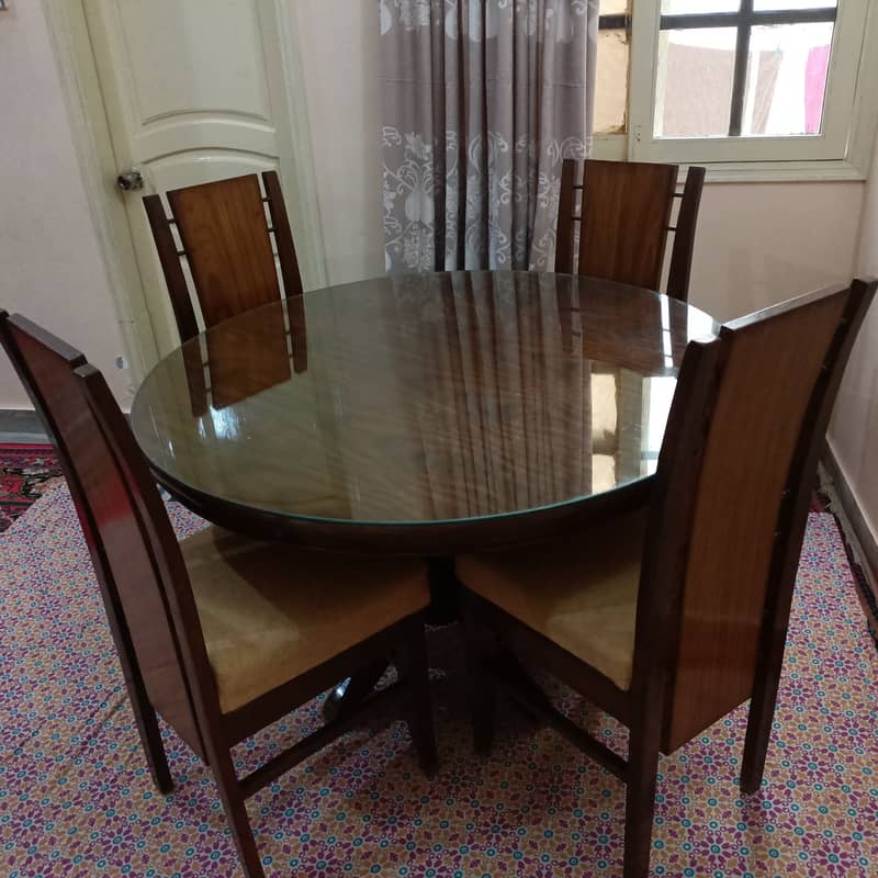 Round Dinning Table with 4 chairs. Glass placed over wooden top 3