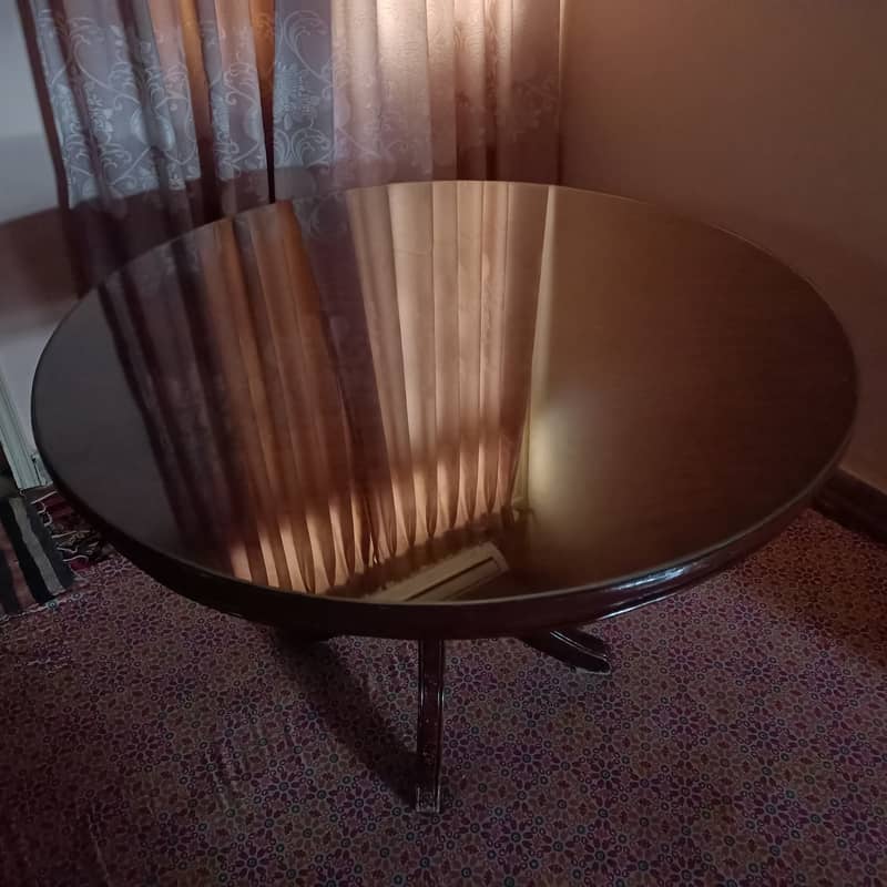 Round Dinning Table with 4 chairs. Glass placed over wooden top 8