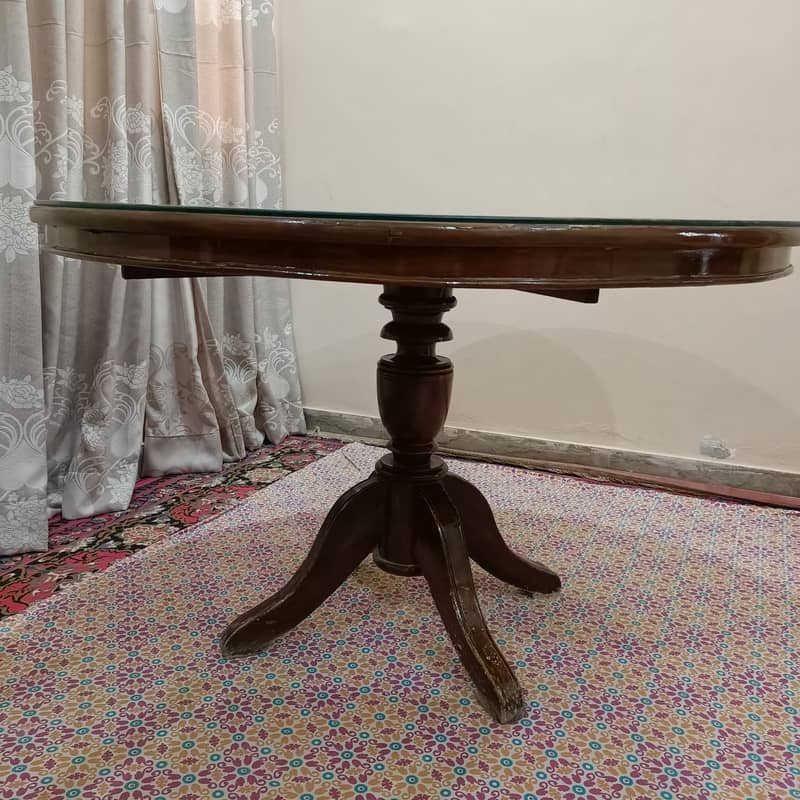 Round Dinning Table with 4 chairs. Glass placed over wooden top 9