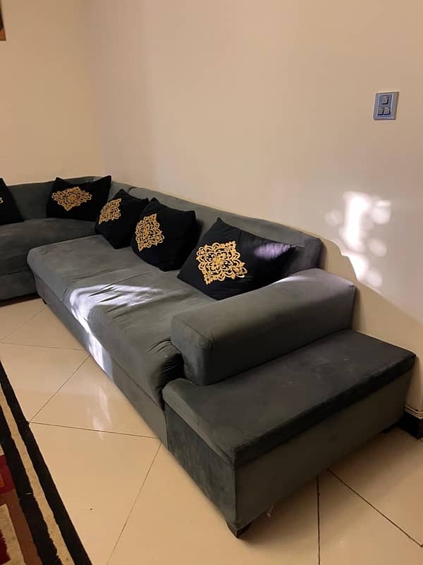 Corner sofa along with table and 6 stools. 1