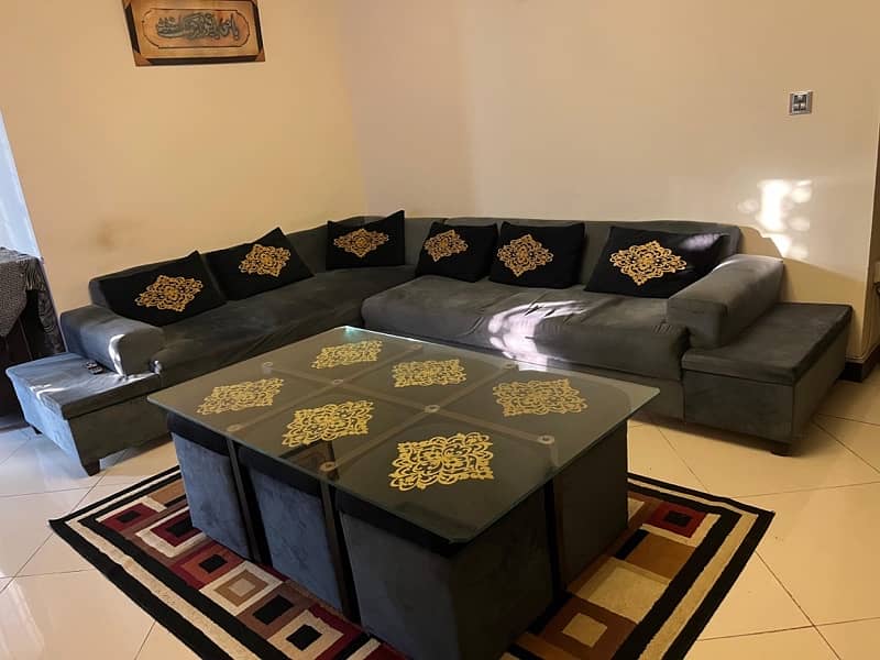 Corner sofa along with table and 6 stools. 2