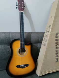 Acoustic guitar with box and picks