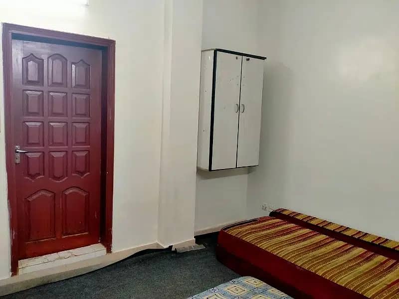 furnished room with attached bathroom and kitchen 1