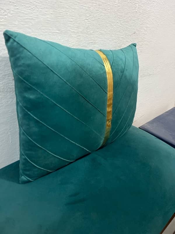 A rectangular teal velvet throw pillow with a vertical gold stripe 3