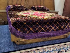 Elegant King-Sized Wooden Bed with Carved Headboard