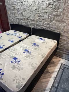 2 single beds with spring mattresses