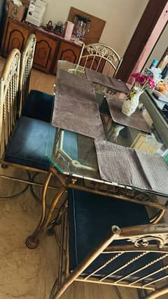 iron dining table with 4 cushion chair