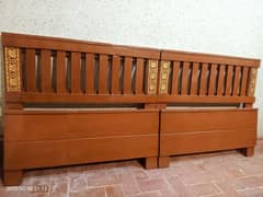 2 wooden single beds