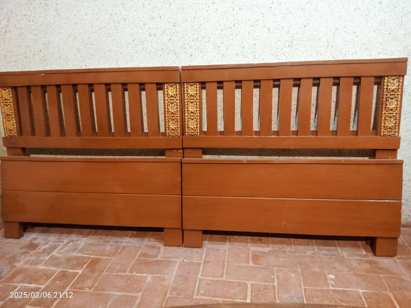 2 wooden single beds 1