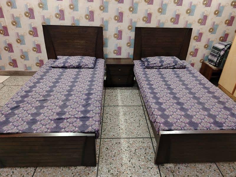 Two Single Wooden Beds with side table 0