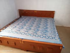 2 wooden single beds