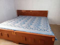 2 wooden single beds