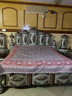 king sized bed with sidetable and dressing and mirror