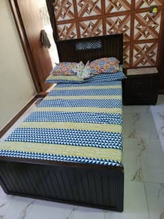 bed without mattress & side table