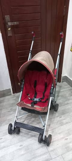 Junior Brand Imported backspin stroller with umbrella cover.