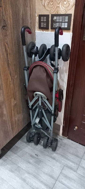 Junior Brand Imported backspin stroller with umbrella cover. 4