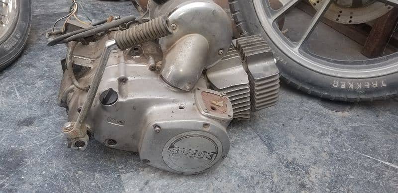 engine suzuki 100 ,alloy rims ,fuel tank, rx 115 shoks 15