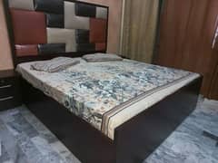 wooden bed with mattress