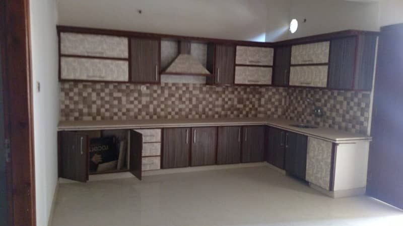 Like new 120yd 4bed dd 2 kitchen double story bungalow boundary wall near block7 jauhar 1