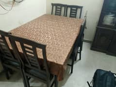 large wooden dining table with 6 chairs