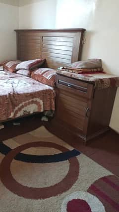 used wooden bed with side tables and mattress