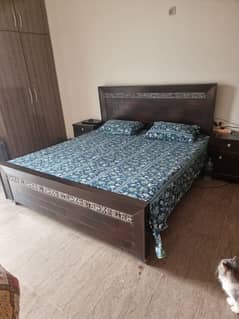 Wooden bed with two side tables