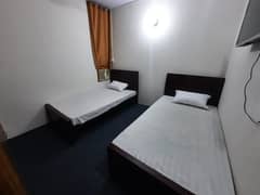 Furnished Independent LDA Flat/ Apartment with Carpeted 2 Rooms for Rent in Q Block Model Town Lahore with AC, Fridge, LED TV, Curtain, Stove, Beds, wood work, UPS, Tiled TV Lounge, Kitchen & bath room Rent = 32000